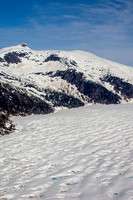 Glaciers, mountains, and snow in and around Taku Inlet taken from a De Haviland DHC-3 Otter of Wings Airways