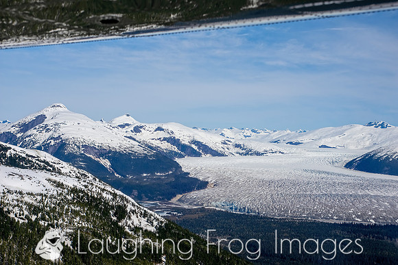 Glaciers, mountains, and snow in and around Taku Inlet taken from a De Haviland DHC-3 Otter of Wings Airways