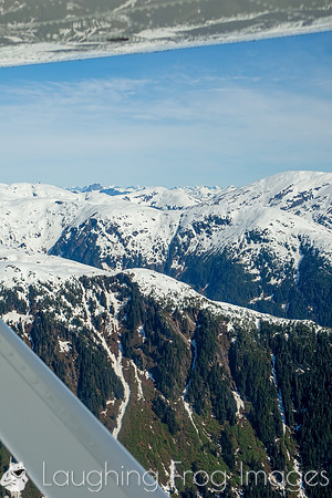 Glaciers, mountains, and snow in and around Taku Inlet taken from a De Haviland DHC-3 Otter of Wings Airways