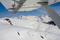 Glaciers, mountains, and snow in and around Taku Inlet taken from a De Haviland DHC-3 Otter of Wings Airways