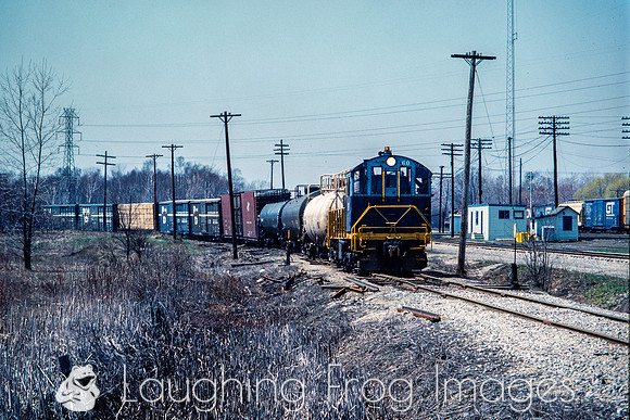 PH&D 60 pulls east with a GT train pulling west in the background, Michigan Road 4/1984.